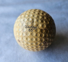 DUNLOP 65, ENGLAND 6. GOLF BALL. PRETTY WELL BEAT UP. NICE PATINA.