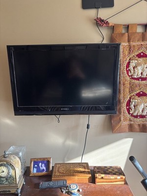 DYNEX Wall mounted TV with wall mount.