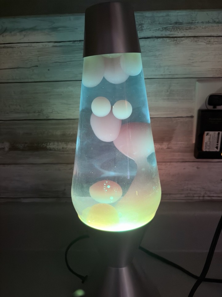 Wide-body vintage lava lamp in blue and yellow with a silver base — an unusual color combo that's harder to find than the classic red/gold.