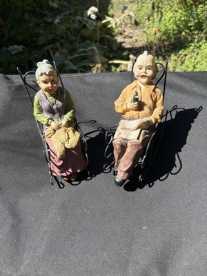 Adorable Older Couple Sitting In Wire Rocking Chairs Doing Their Favorite Things