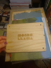 wooden board with the "Mondo Llama" logo engraved on it,
