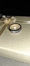 silver-tone ring with colorless crystals.
