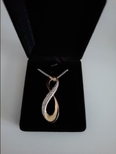 A Quality Ladies Infinity Pendant With Sterling Silver Chain.