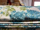 very large roman blind in bright turquiose blue and green fabric. with track