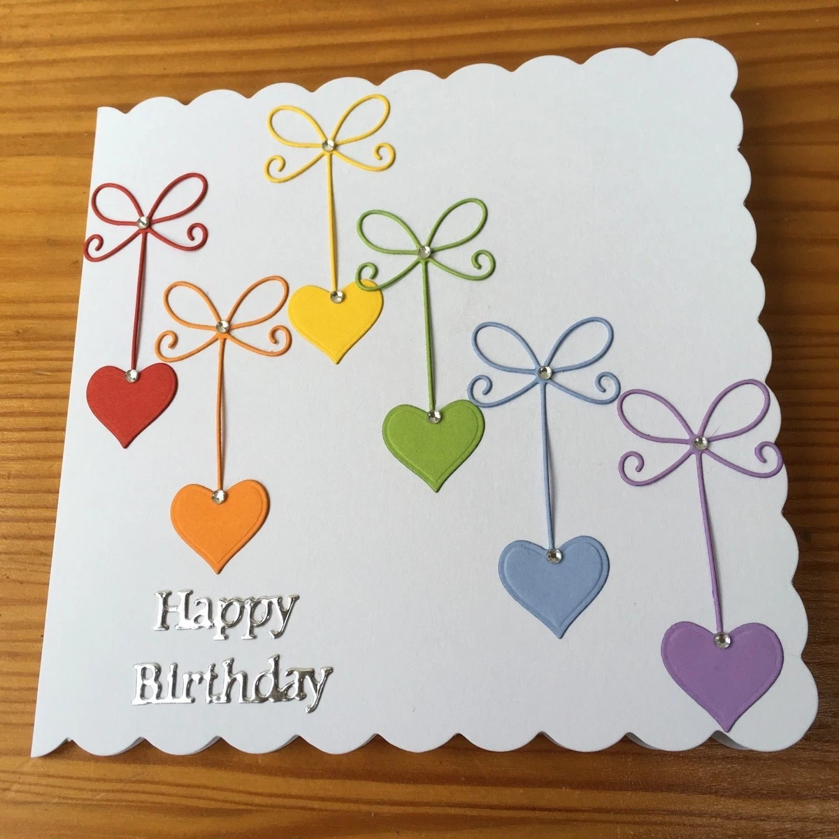 Handmade Happy Birthday card hanging rainbow hearts with faux gems