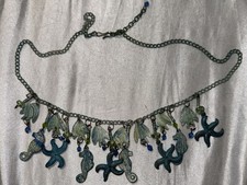hand-painted sea life charm necklace featuring starfish, seahorses, and shells.