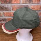 Green vintage baseball cap with red and white stripe, embroidered “K-Products USA Made” text, and red and white logo on front.