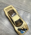 Hot Wheels Jaguar XJ220 * Color: Dorado metálico con gráficos azules y negros — photo 1