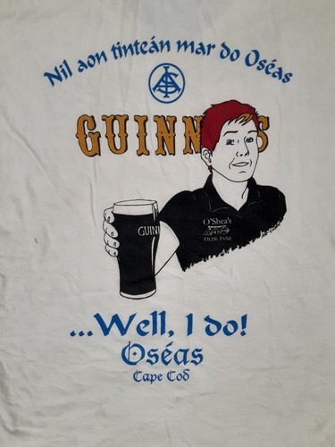 White vintage cotton T-shirt with Guinness logo, cartoon man, and text “Nil an Pointeán mar do O’Shea’s Cape Cod.”