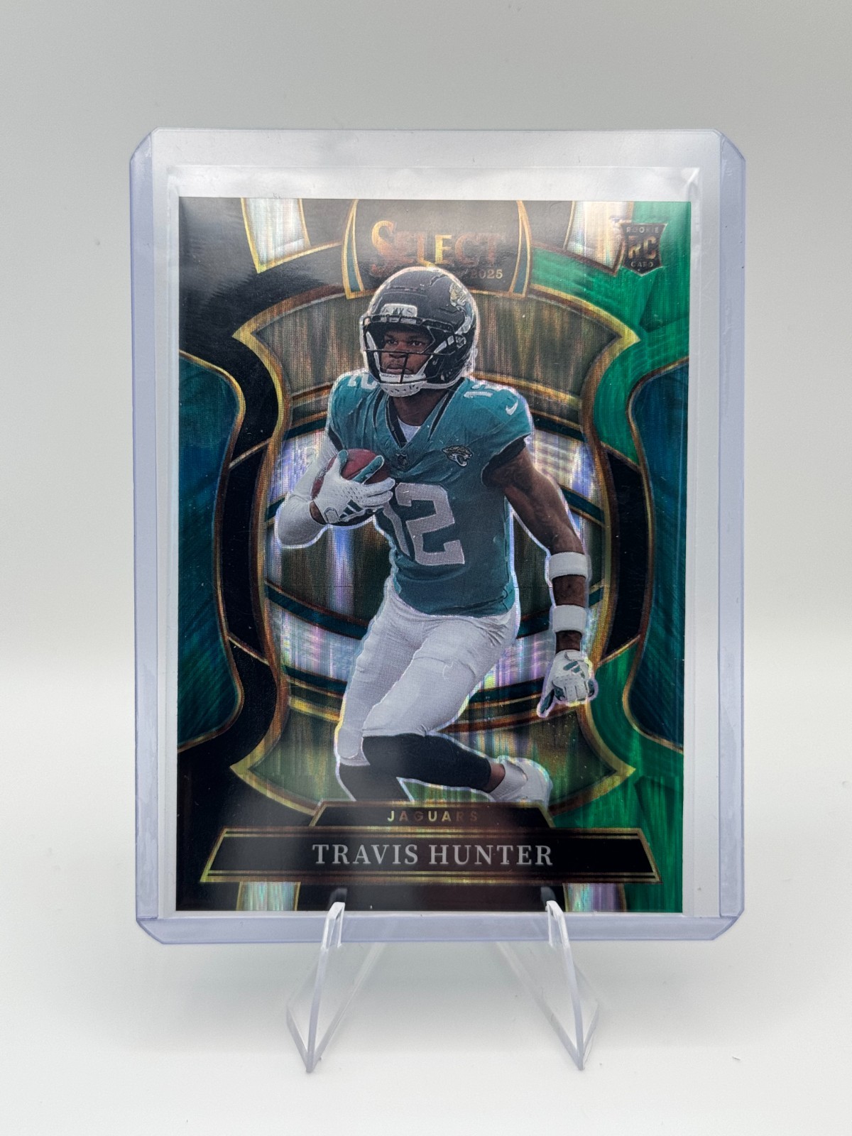2025 Panini Select 28 Travis Hunter Black & Green Shock Prizm Concourse Jags NFL