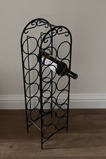 Black Wrought Iron Wine Rack. Holds 12 Bottles. New. Buyer To Collect.