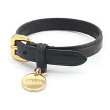 Pre-owned Prada bracelet in black with gold hardware and leather. Bangle with