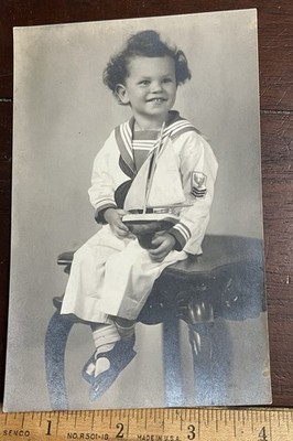 Photo of Richard Walling wearing sailors outfit, holding a sailboat. Taken LA CA