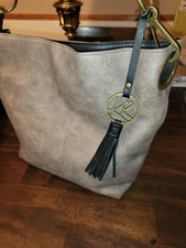 kim rogers Taupe Distressed Shoulder Bag Tassel Logo Charm Black Strap