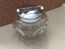 A vintage glass sugar cube bowl and a mechanical tonged lid