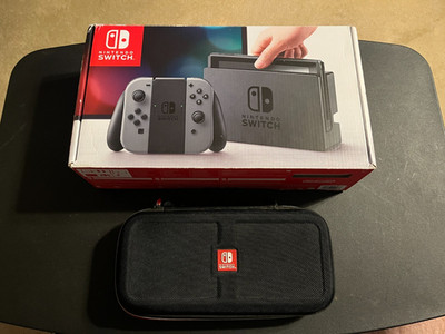 Nintendo Switch Model HAC-001 with original box, accessories, and travel case