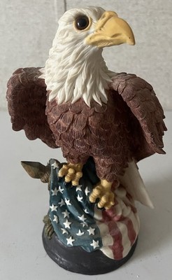 Bald Eagle Perched on the American Flag Figurine on Wood Stand