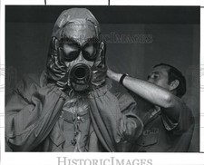 1990 Press Photo PD Reporter, Chris Jensen is fitted with an air mask
