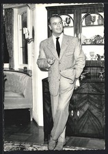 Postcard actor O. W. Fischer standing smoking in front of a chest of drawers 