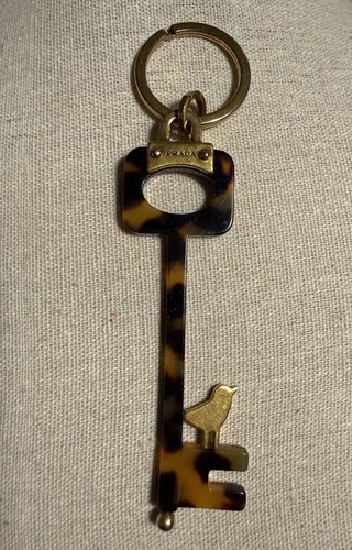 PRADA Tortoise Shell Resin Key Keychain Bird Charm Gold Tone