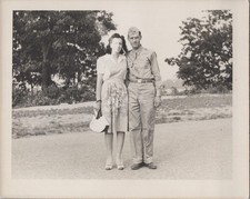 WW2 Photo of Soldier and Woman Standing on Road Near Open Fields