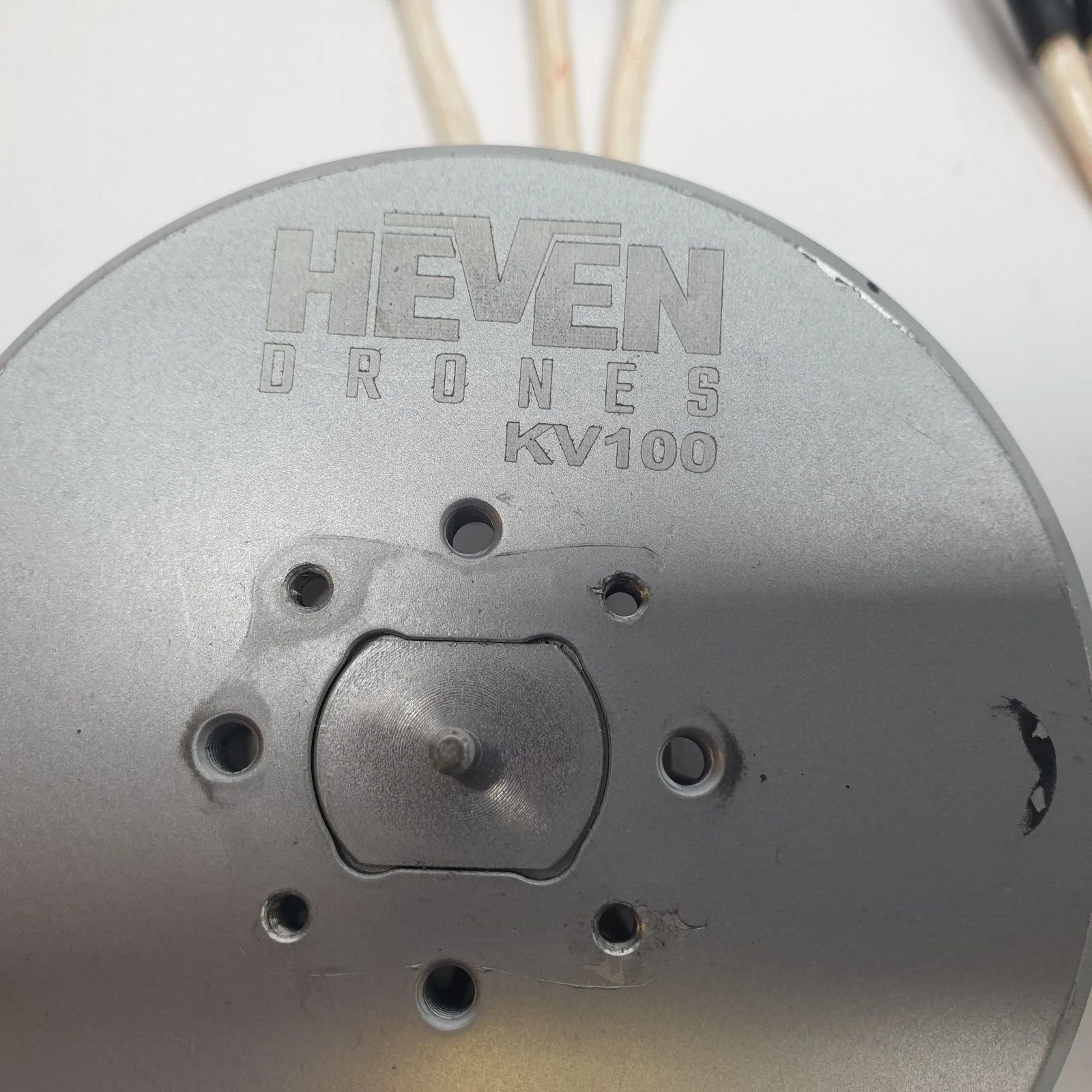 Top of a Heven Drones KV100 motor: recessed plate, center shaft and six holes