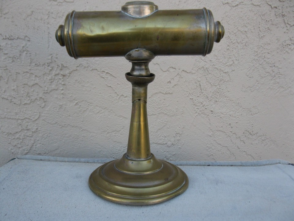 A patent-dated 1879 brass student lamp that converts between desk and wall — antique lighting with a verifiable birthdate older than most countries' governments.