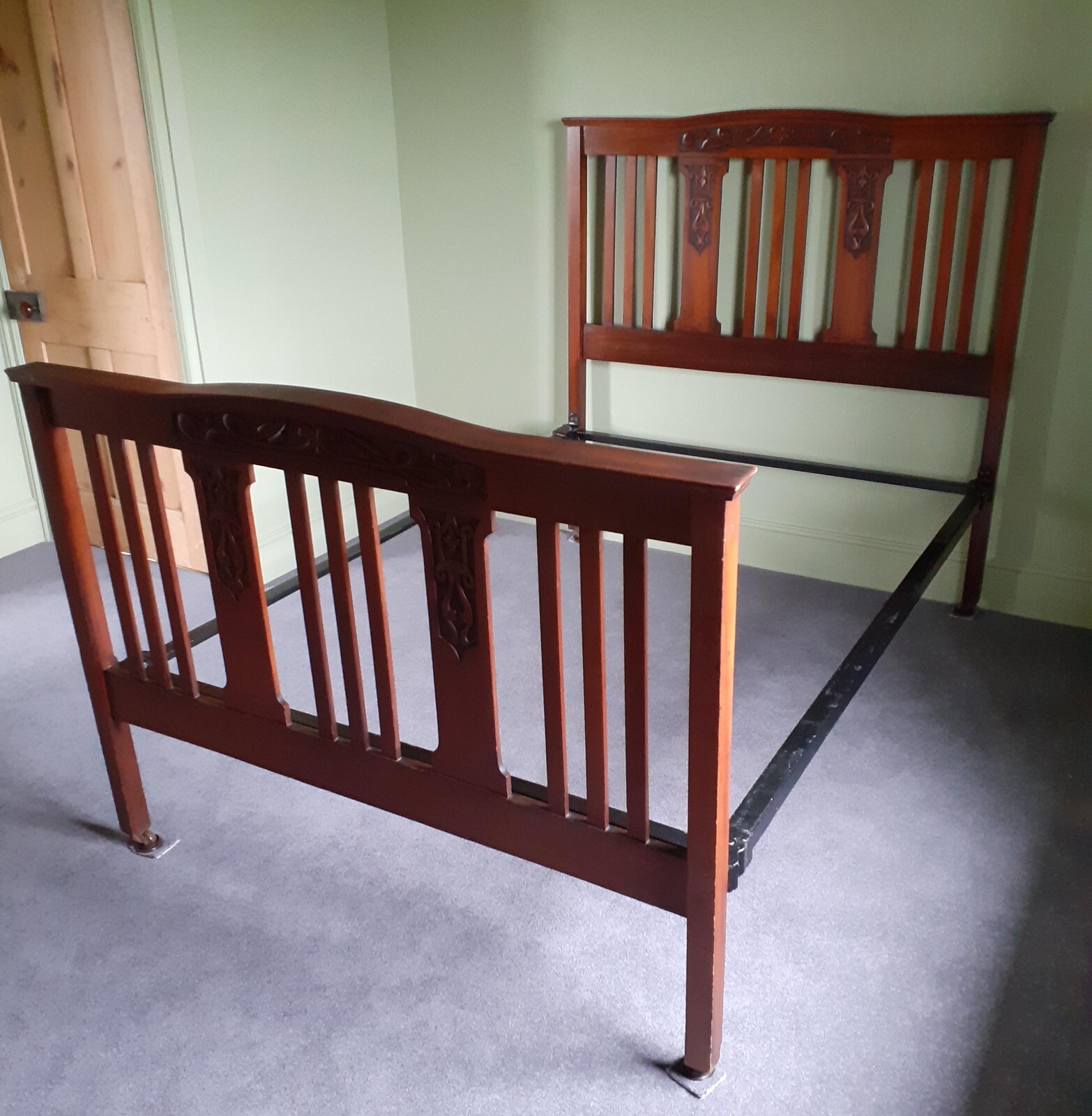 antique wooden double bed with metal frame and mahogany head and