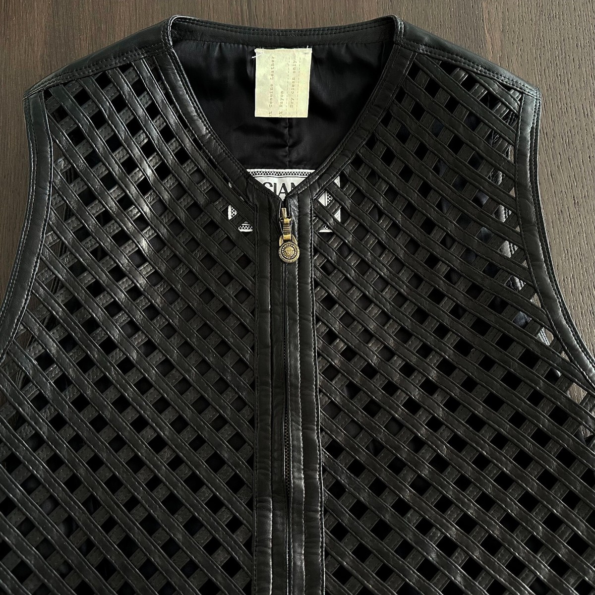 1994 GIANNI VERSACE black leather vest w/ an open lattice feature