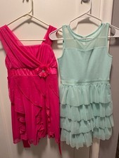 Girls formal dresses size 10-12. Includes two dresses. Ruffle party dresses
