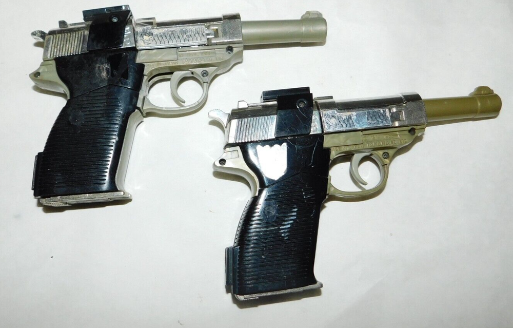 Two Vintage Megatron Decepticon Transformer Walthers P-38's