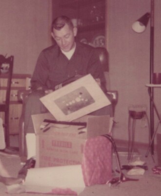 Man Smiling During Christmas 1968 Joyful Moment with Gifts