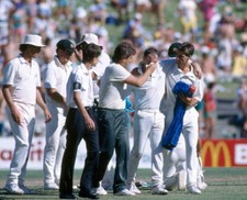 Australia's wicketkeeper Greg Dyer is assisted off the field afte - Old Photo