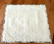 White Quilted Table Topper, liner on the back with blue flowers, about 19x 18