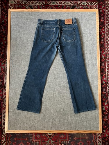 VTG 1990s Levi’s Superlow 518 bootcut jeans, dark wash, waist 31, back view with stitched seams and red Levi’s tag.