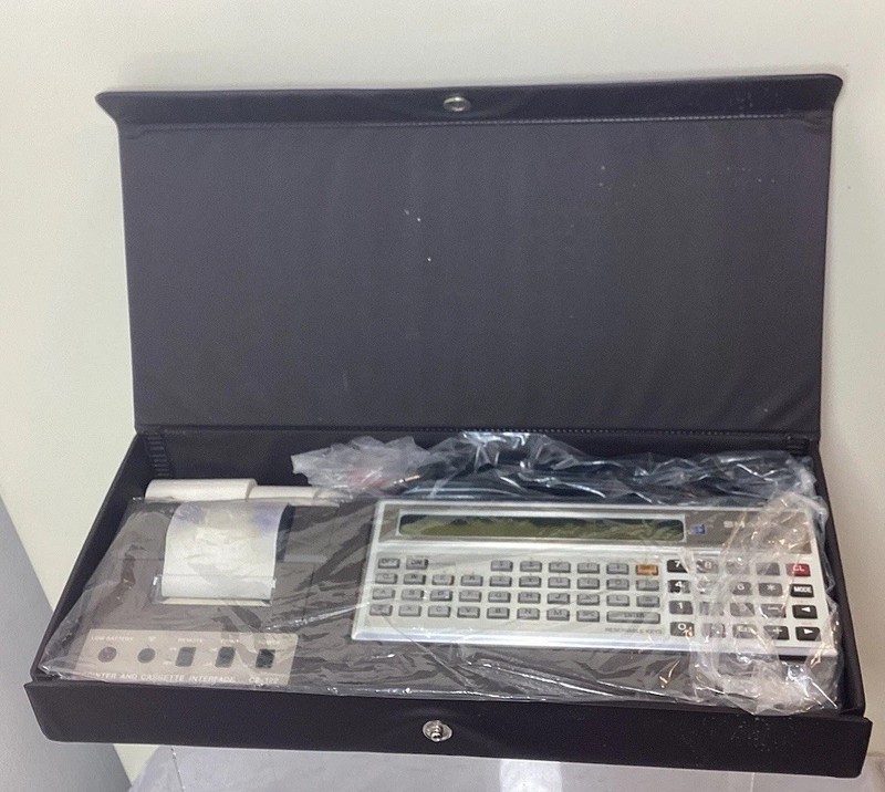The Sharp PC-1211 is a Vintage Pocket Computer in Systems Carrying Case