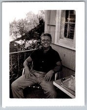 Vtg B&W Snapshot Smiling Man Sitting Lawn Chair Porch Deck Polaroid Photo 1950s