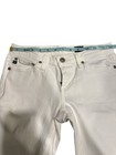 White AG Adriano Goldschmied jeans 25R with button closure, belt loops, and silver rivets, shown on mid-thigh leg.