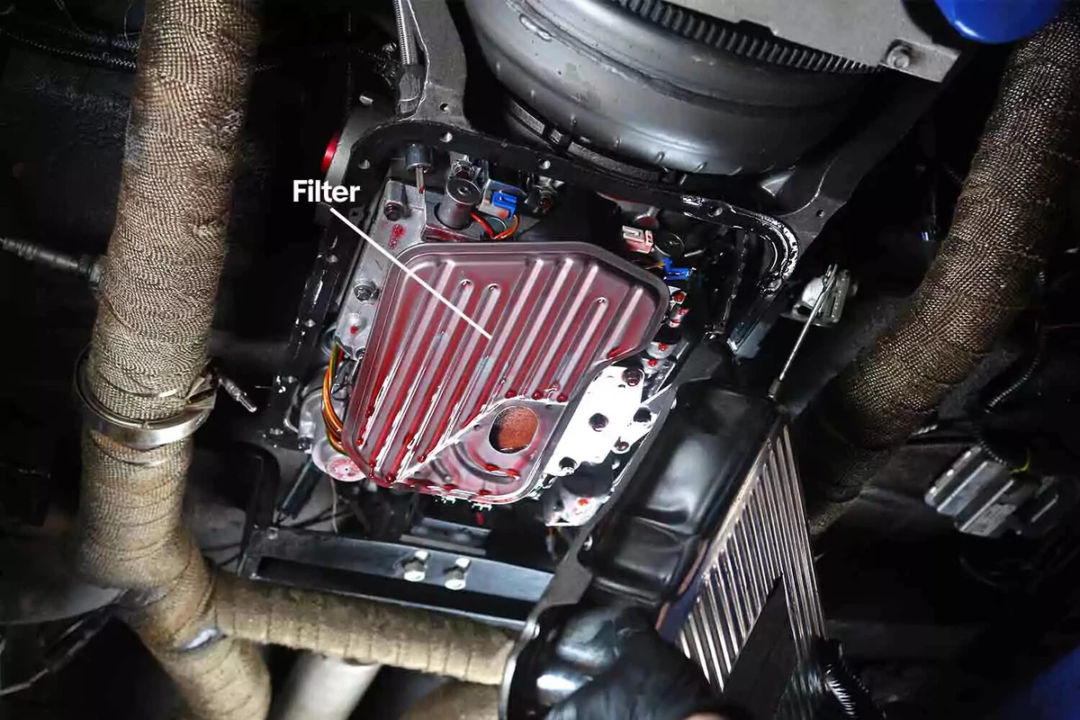 A transmission filter exposed after the lid of the transmission pan is removed.