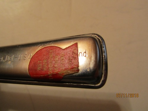 Vintage Playtex hair cutter with red plastic handle, silver bowl, and engraved text “Made in U.S.A.” on side.