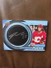 2022-23 Sean Monahan Auto &  Puck Upper Deck Trilogy Signature Pucks  (#SP-SM)