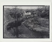 PHOTO FROM NEGATIVE OF RAMSHACKLE HOUSES COLLAPSING INTO CREEK 