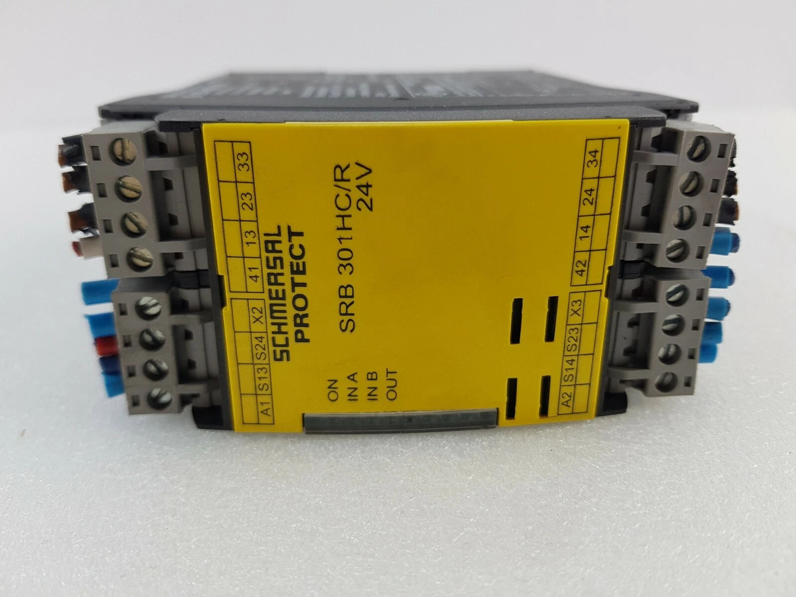 Front of Schmersal SRB 301HC/R 24V showing terminal numbers and ON, IN A, IN B, OUT LEDs