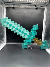2 Minecraft pixelated sword. Teal and Brown sword