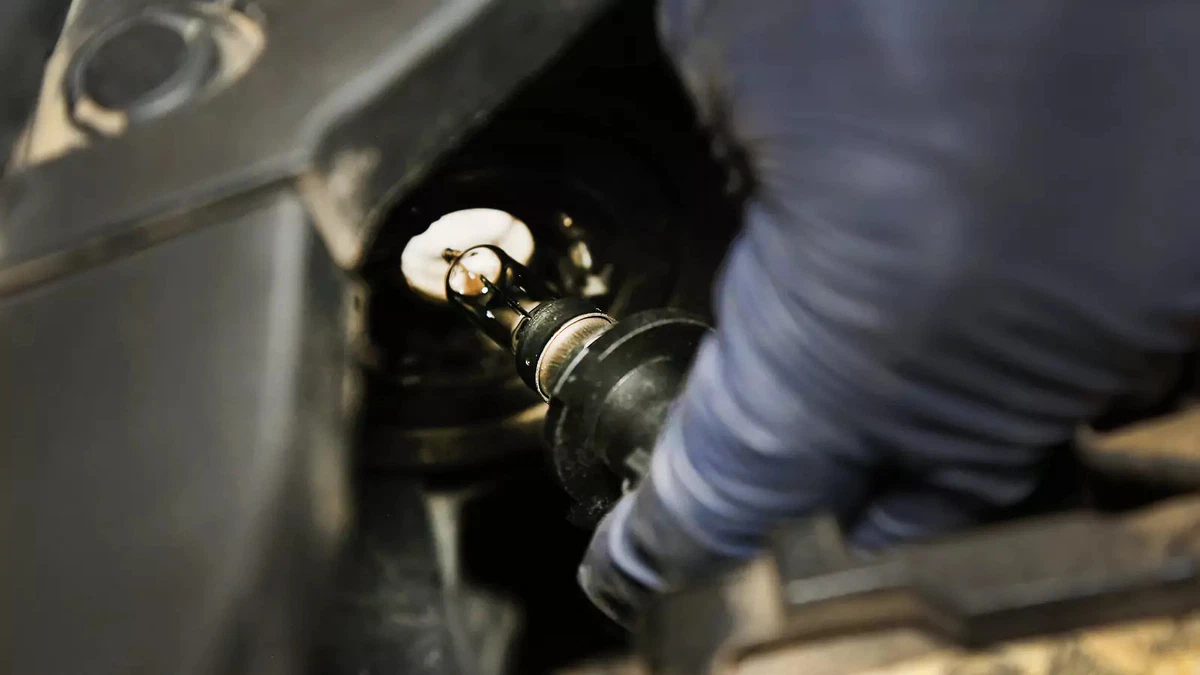 Carefully installing the headlight bulb into the housing.