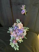 Wedding bouquet In Hand tied Cascade Style In Dusty Purple And Lavender.