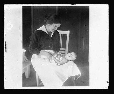 Photo:1910s Nurse with Baby Portrait Indoor Infant Care