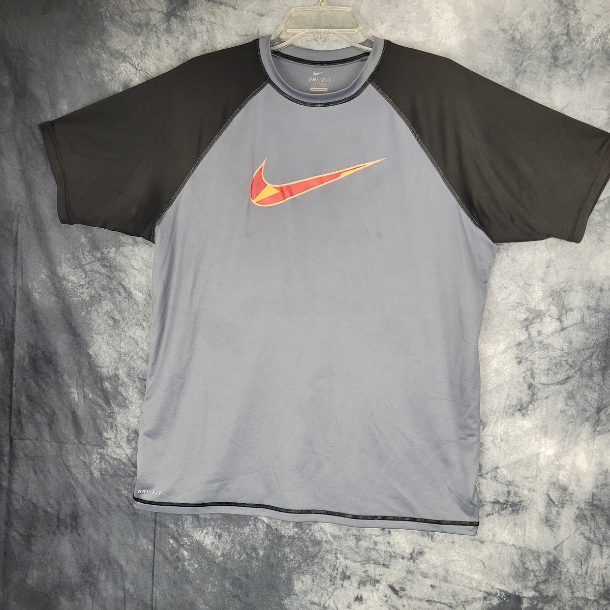 white black and orange nike shirt