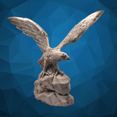 sculpture of an eagle with its wings spread, perched on a rocky base. (#139)
