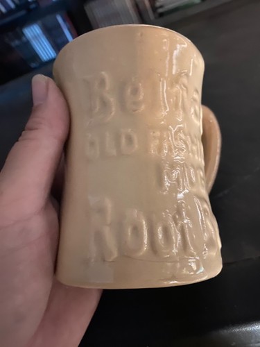 Beige mug with “Belfast Old Fashioned Root Beer” text, wavy front edge, and “Made in U.S.A.” sticker.